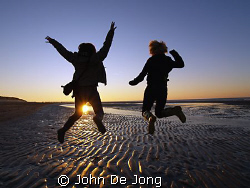 Jump.

My doughter Kim and hier friend Manon at the bea... by John De Jong 